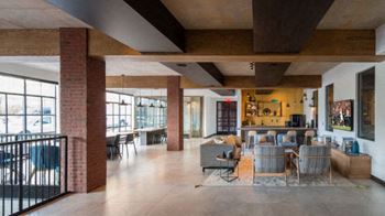 a large living room with a table and chairs